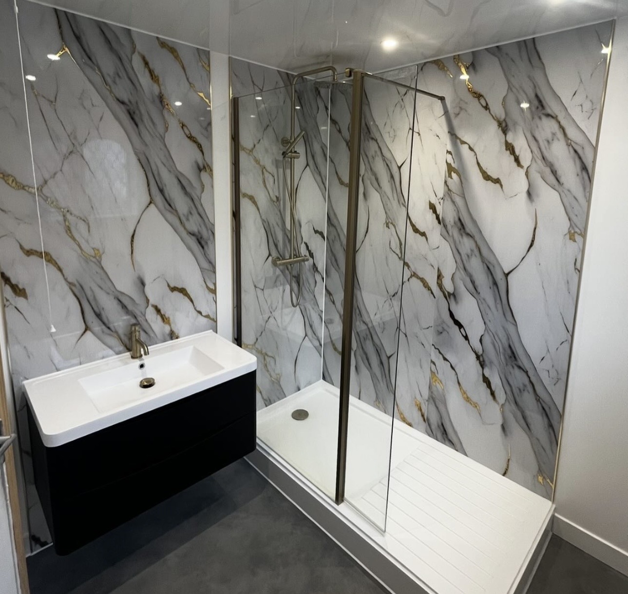 Luxury walk-in shower with marble and gold detailing installed by M3 Trades