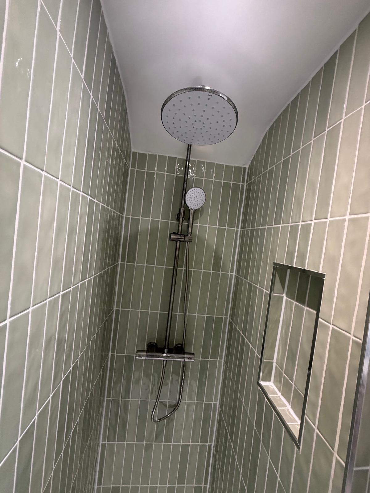 Sage green vertical metro tile shower enclosure with chrome thermostatic shower and tiled niche in Rubery Birmingham by M3 Trades