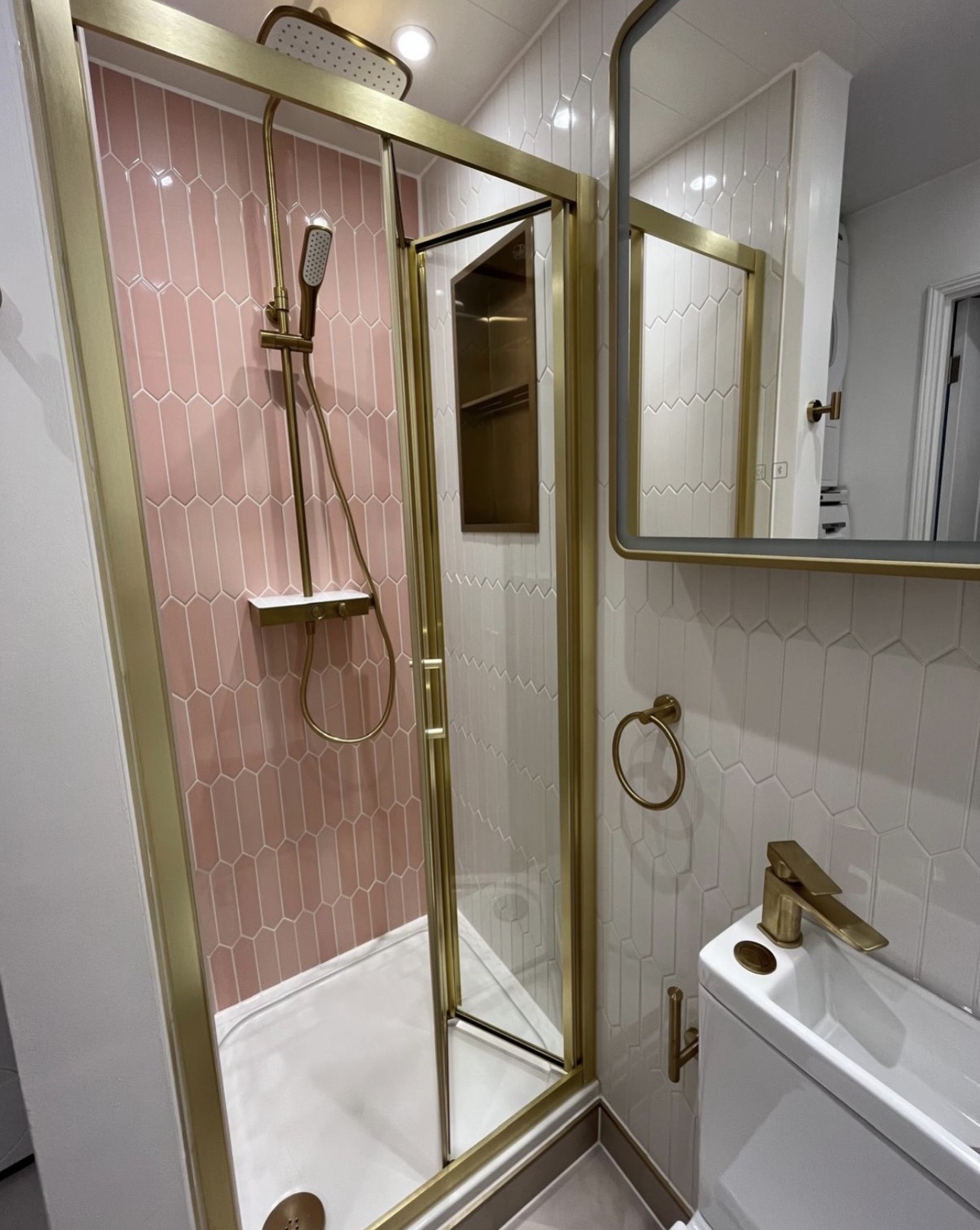 Compact upstairs shower room with pink picket feature tiles and brushed brass fittings in Birmingham by M3 Trades